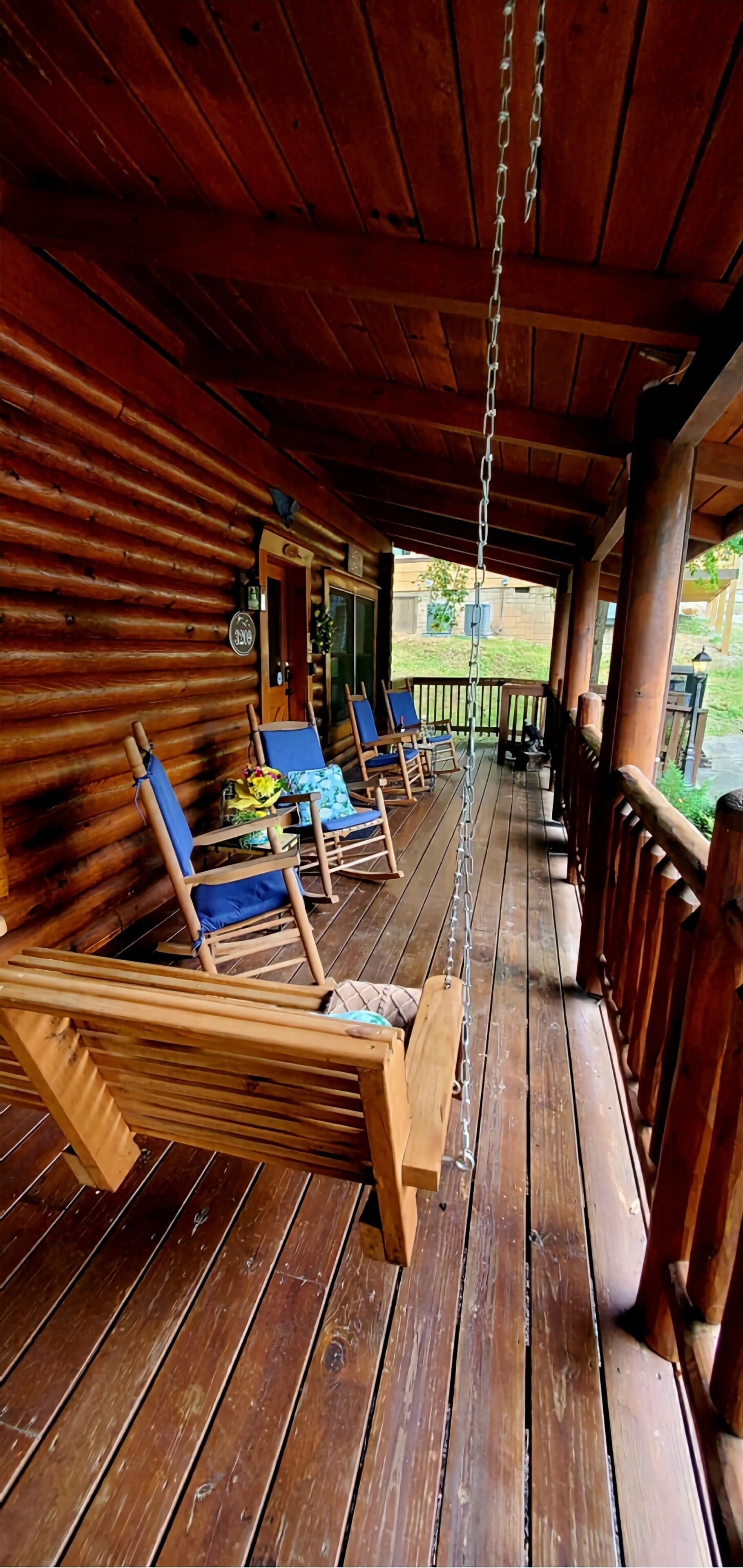 Eine Holzterrasse mit Liegestühlen und einer Hängematte.