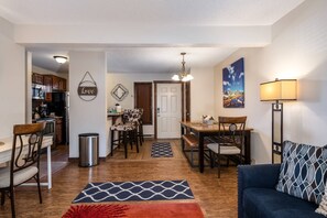 A compact living space with a kitchenette, dining area, and seating area. - August Monthly Rates! Summer Pool + Hot Tub-Grill-W/D in Unit-Walk to Mtn/Steps to Free Town Bus (Steamboat Springs)