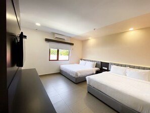 A hotel room with two beds, a large window, and a flat-screen TV mounted on the wall. - The Concept Hotel Langkawi (Langkawi)