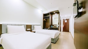 A hotel room with two beds, a wardrobe, a mirror, and a television. - The Concept Hotel Langkawi (Langkawi)