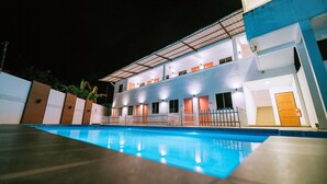 A modern hotel with a swimming pool, multiple balconies, and a well-lit exterior. - The Concept Hotel Langkawi (Langkawi)