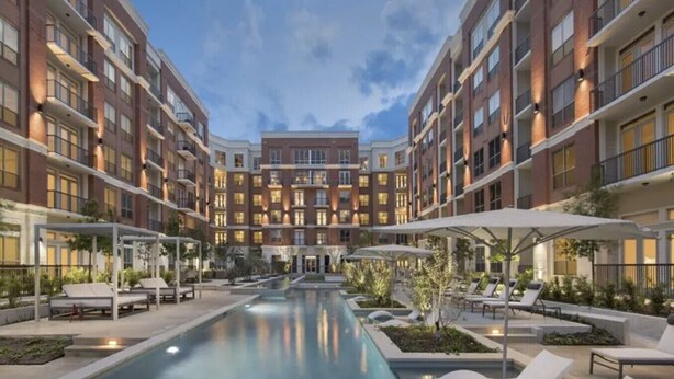 A modern hotel with a central pool, outdoor seating, and a courtyard. - Resort Style 2 bed/2bath Apartment in Spring, Tx (Spring)