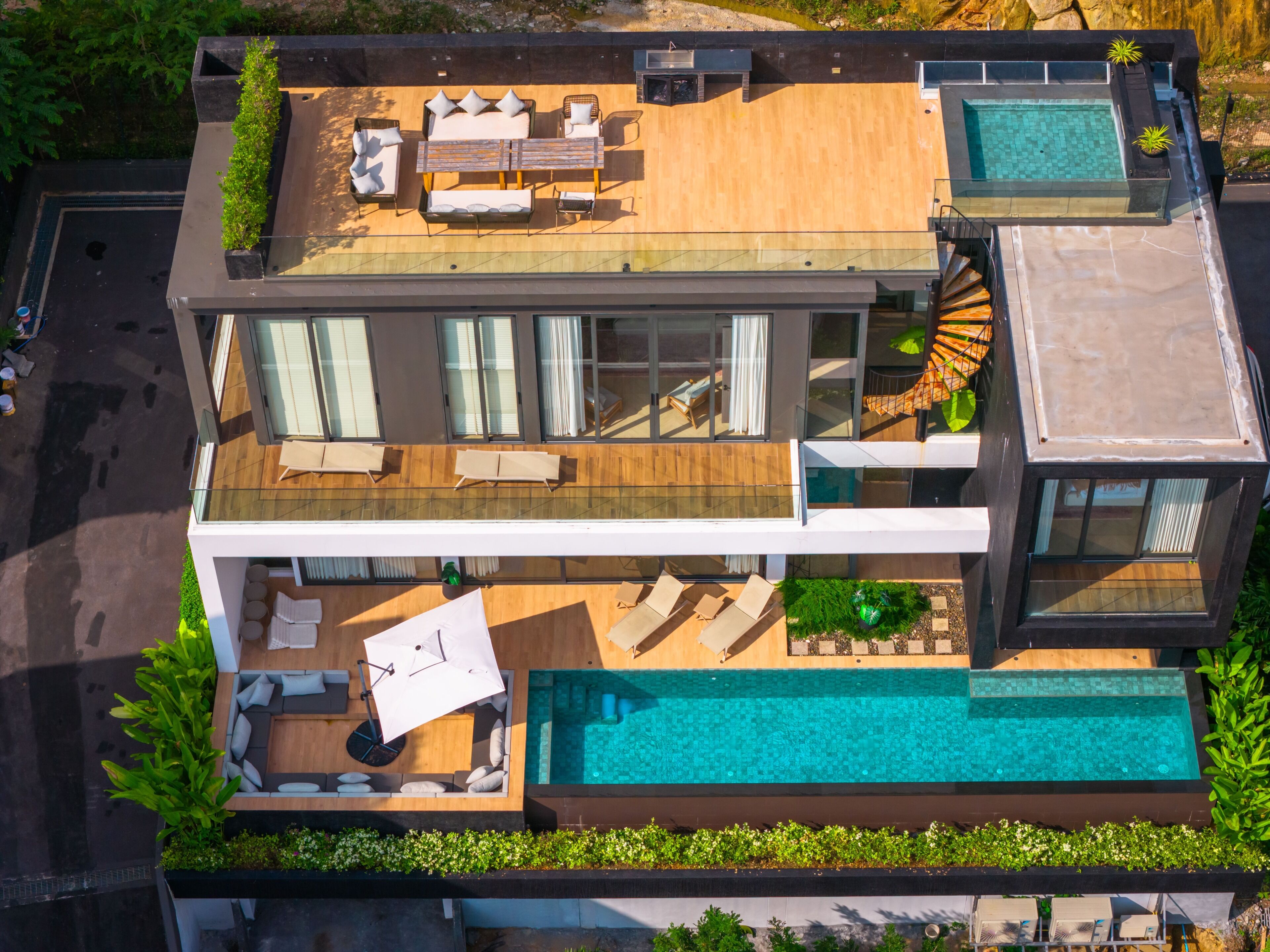 A modern two-story house with a rooftop deck, a swimming pool, and a spiral staircase.
