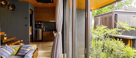 A modern interior with a pool area, wooden ceiling, and a view of the outdoors.