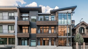 A modern multi-story building with a prominent entrance labeled "THE LOFTS @ 660". - Mountain Modern Condo Near Downtown (Ketchum)