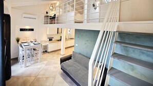 A modern interior with a staircase, a dining area, and a kitchen.