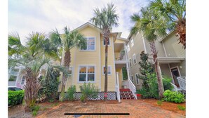A two-story residential building with a brick pathway leading to the entrance. - Above the Sea in Old Florida Cottages. South of 30a, Sunset views, Mins to beach (Santa Rosa Beach)