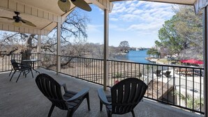 A covered outdoor area with chairs and a view of a river. - Horseshoe Bay - Lakefront + Pool - Lucy on the Lake (Horseshoe Bay)