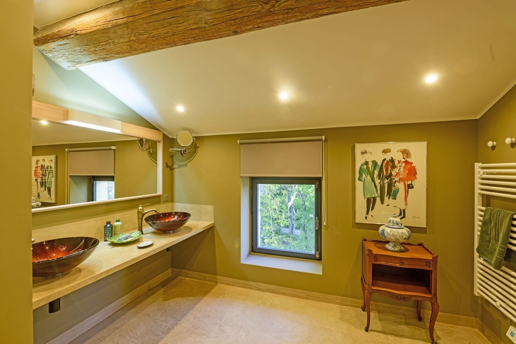 A bathroom with a large mirror, two sinks, a window, and a radiator.