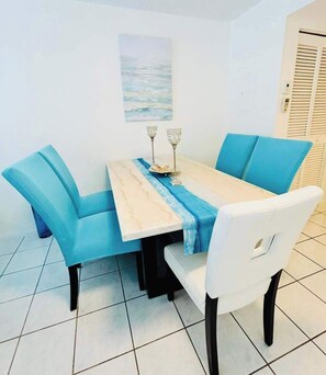 Enjoy meals for two at this elegant dining area with a table, chairs, and decorative accents.