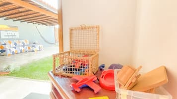 Enjoy a serene view from this room, featuring a wooden counter with a wicker basket and a convenient storage container.