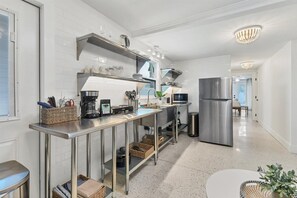 Enjoy cooking in this well-equipped kitchen with a coffee maker, microwave, and stainless steel refrigerator.