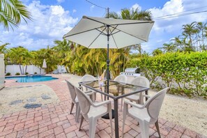 Enjoy al fresco dining and relaxation by the pool.