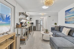 Enjoy a compact yet functional stay with a kitchenette, dining area, and living space featuring a sofa and coffee table.