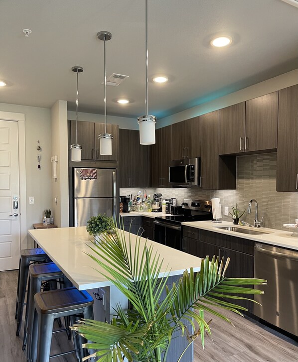 Microwave, dishwasher, coffee/tea maker, cookware/dishes/utensils