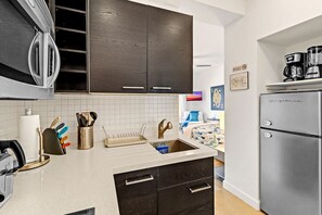 Fridge, microwave, stovetop, coffee/tea maker