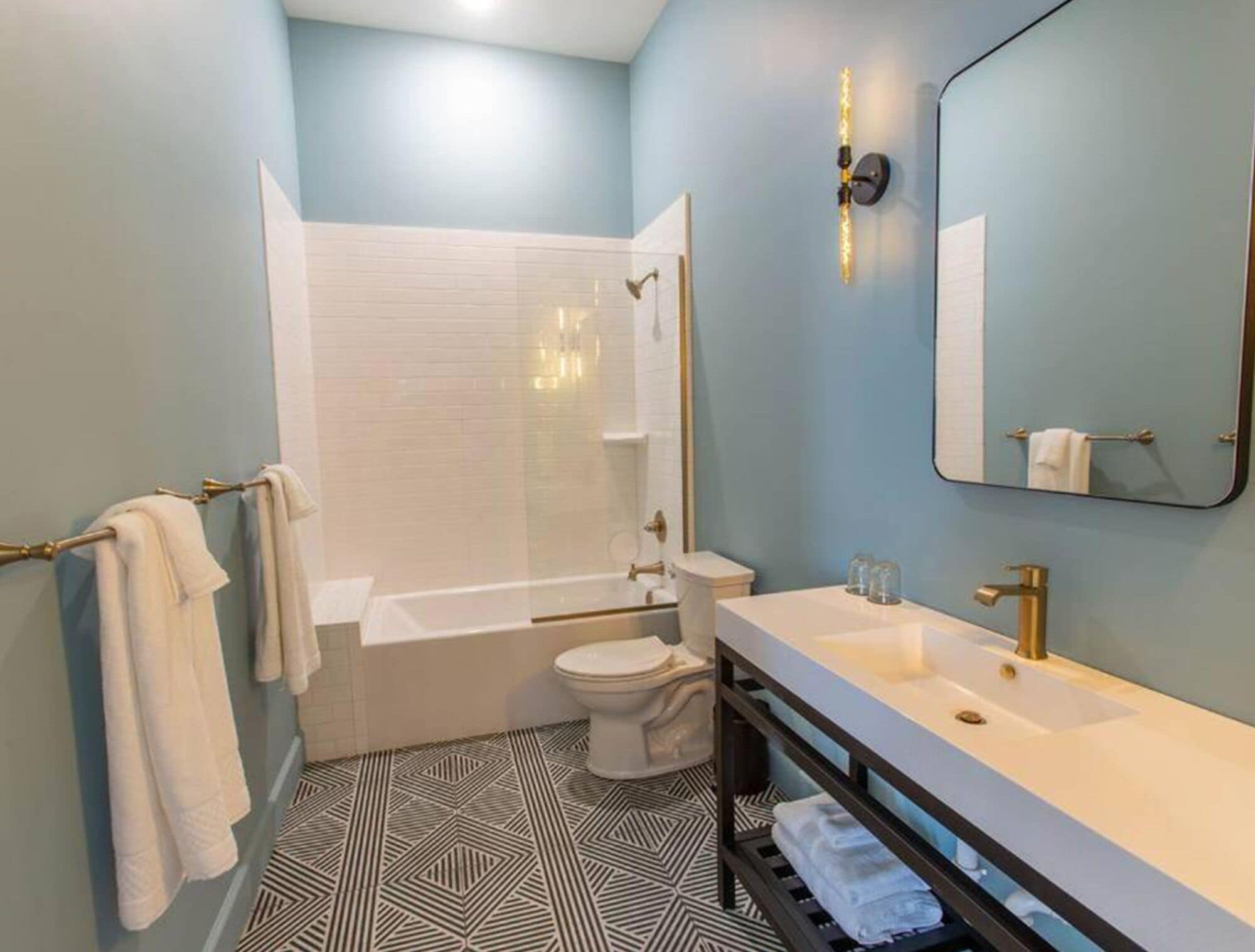 A modern bathroom with a bathtub, toilet, and sink.