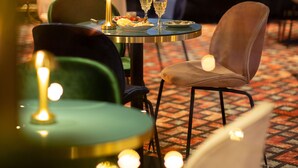 Un restaurant avec des tables rondes, des chaises et des bougies.