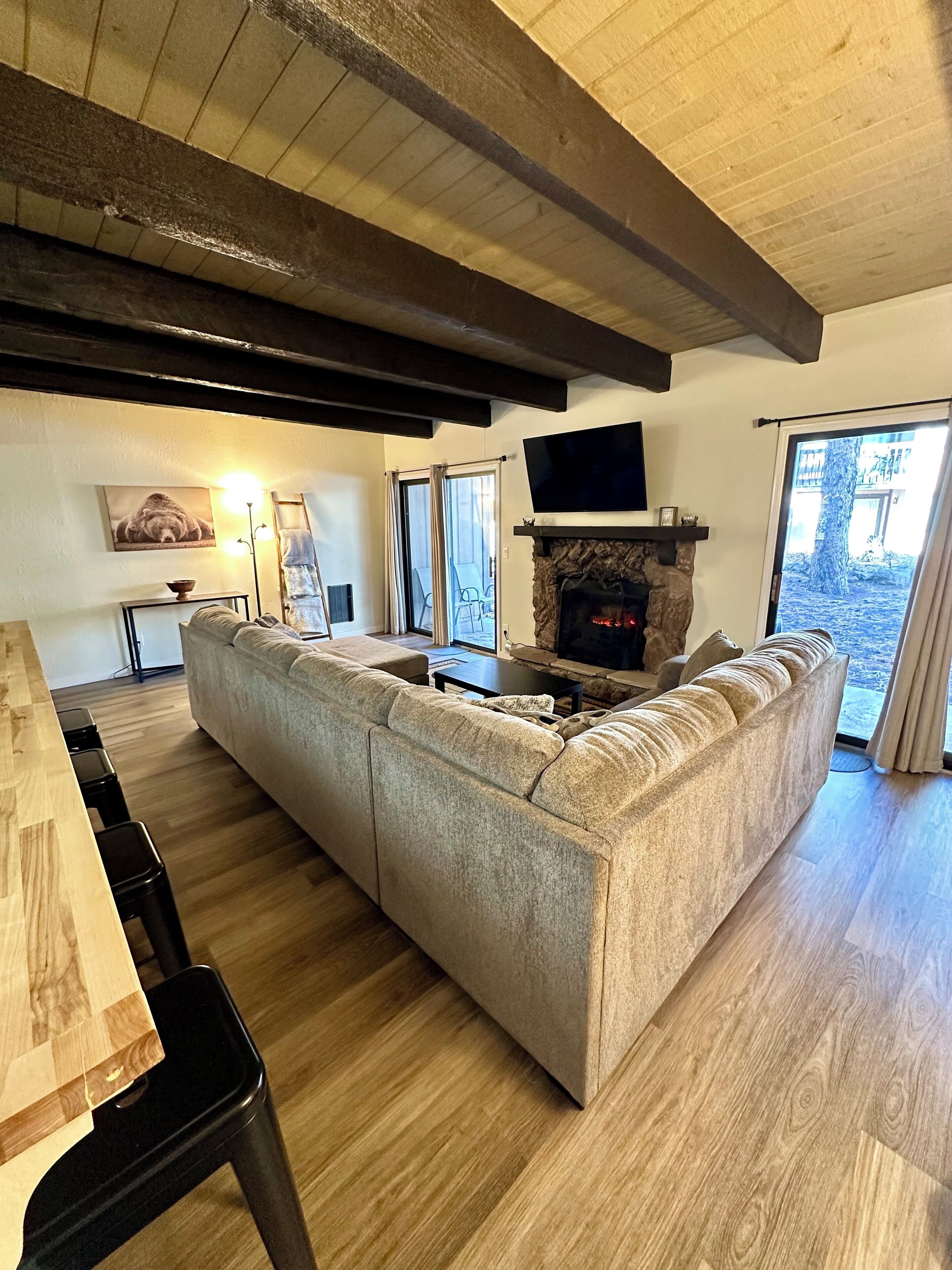 Living room with electric fireplace and Smart TV.