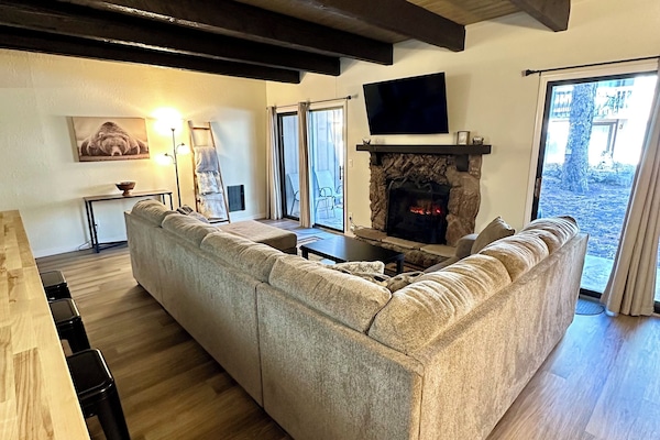 Living room with electric fireplace and Smart TV.