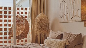 Un dormitorio con una cama, una silla colgante y un mapa mural.