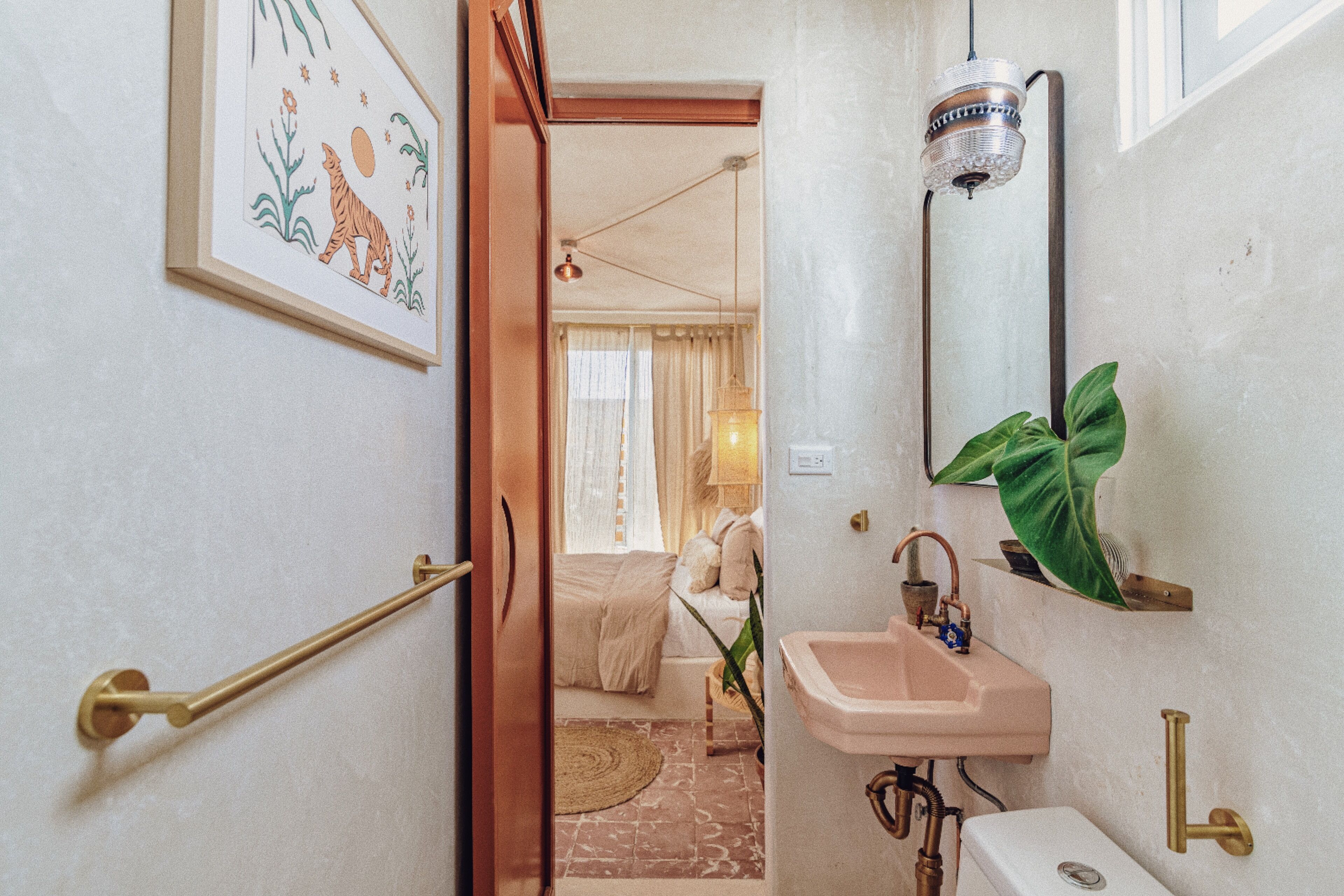 A bathroom with a sink, mirror, and towel rack.