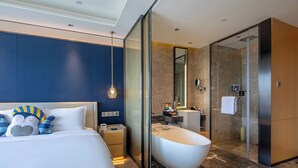 A modern hotel room with a large bed, a bathtub, a walk-in closet, and a bathroom with a glass shower enclosure. - voco Xi'an Etdz by IHG (Xi'an)