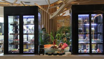A modern interior with glass display cases containing various food items.