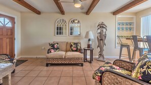 A living room with a sofa, chairs, a dining table, and a ceiling fan. - DIRECT OCEANFRONT BEACH HOME! PRIVATE BEACH ACCESS! (New Smyrna Beach)