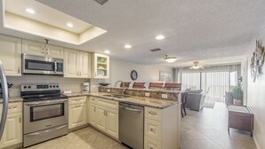 A modern kitchen with stainless steel appliances, a dishwasher, and a granite countertop.