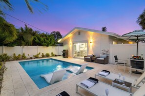 A heated pool, pool loungers