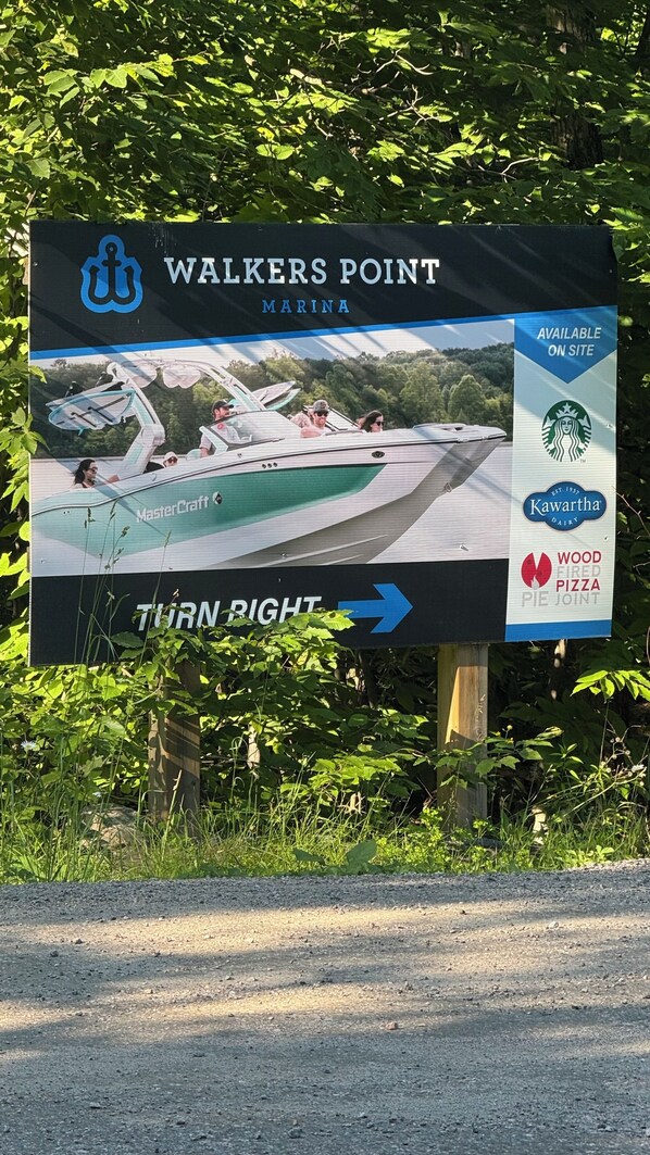 A sign for Walkers Point Marina with a direction to turn right.