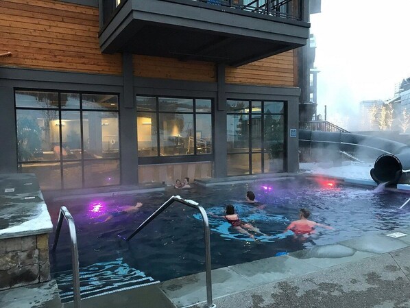 Guests can enjoy a refreshing swim in the pool surrounded by a deck with a ladder.