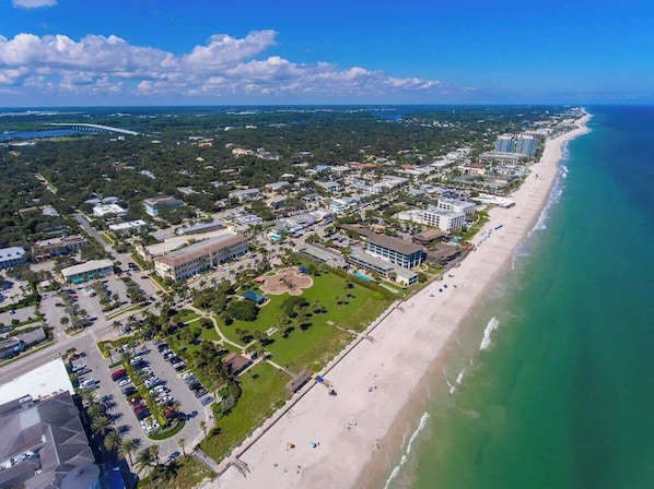 An aerial view of a coastal town with a beach, buildings, and a golf course. - Beach Getaway - Private Heated Pool & 2 King Beds (Sebastian)