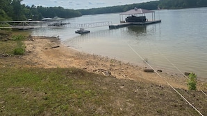 A lakeside area with docks and a covered boat ramp. - Lake Front Home on Buggs Island / Kerr Lake<br>Close to Bluestone Boat Ramp! (Clarksville)