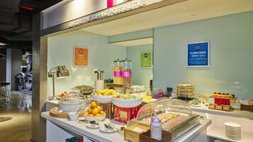 A buffet area with various food items and a sign that reads "TOP Explore the Toping Possibilities".
