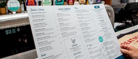 Un menú con diversas opciones de comida y sus precios.