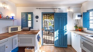 A compact kitchen with a microwave, toaster, and a small sink. - "Rural Village with Amazing Views Cottage" with Mountain Views, Private Pool, A/C & Wi-Fi (Moclinejo)
