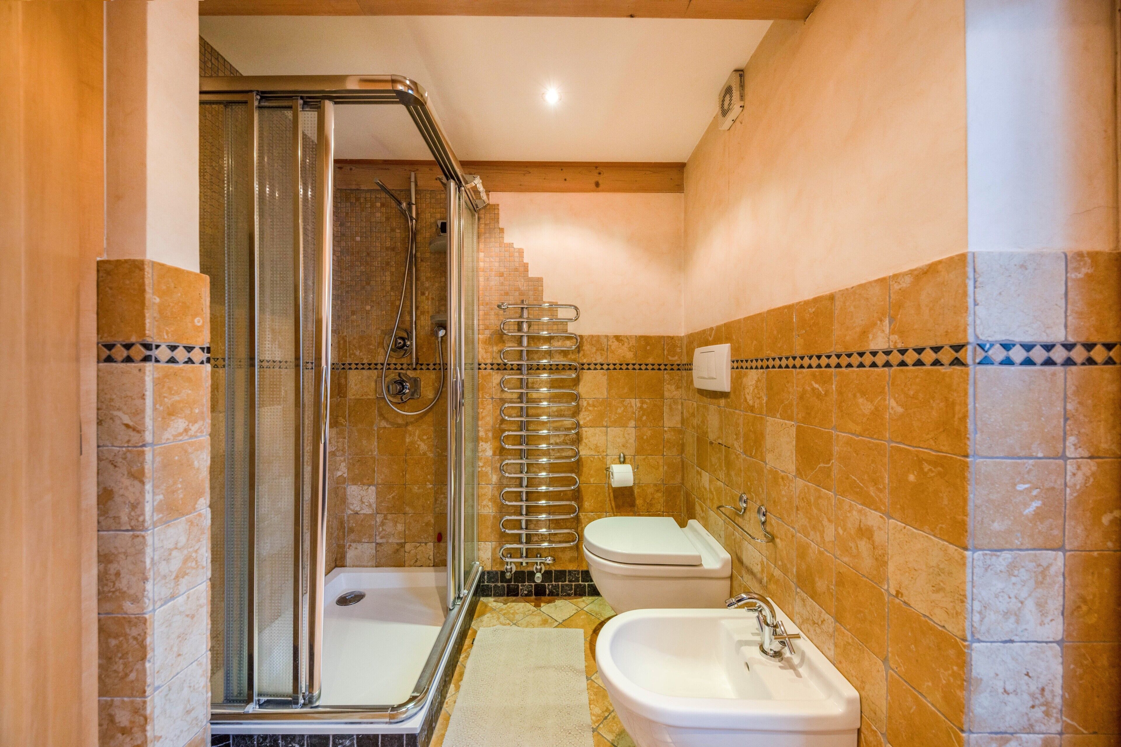 A bathroom with a shower, toilet, and sink.