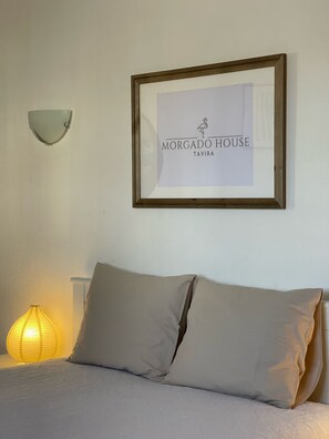 A framed sign with the text "Morgado House Tavira" on a white wall.