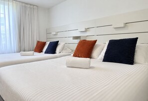 A hotel room with two beds, each with white linens and multiple pillows in various colors. - LUXURY THE YATCH 402- FREE PARKING AND WIFI (Aventura)