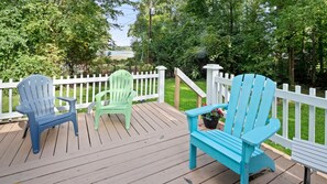 Relax on the deck surrounded by lush greenery and enjoy the serene atmosphere.