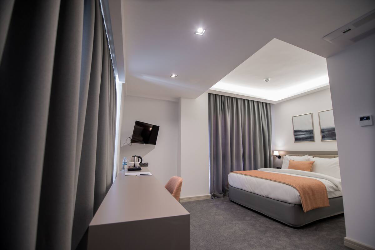 premium bedding, minibar, desk, laptop workspace