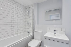 Bañera, secador de pelo, toallas y champú