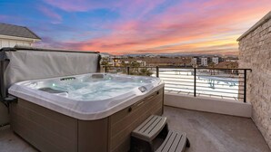 A hot tub on a balcony with a city view at sunset. - Desert Beach: Private Pool, Lagoon + Beaches (St. George)