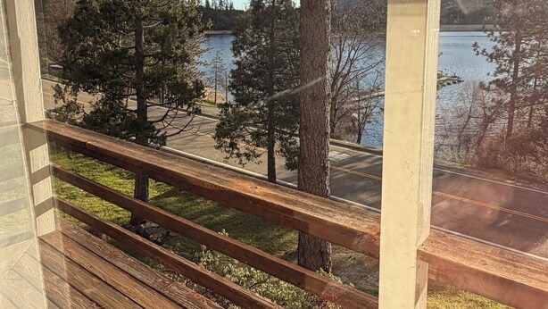 A wooden deck with a view of a lake and trees. - Large 3-story LAKE VIEW 4 bedrooms (all masters) & 5 bath Boat Slip & Marina (Bass Lake)