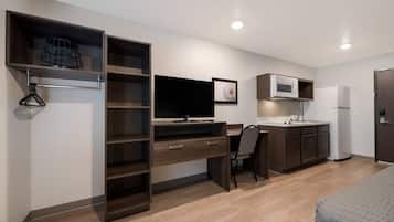 A modern kitchenette with a microwave, refrigerator, and sink.