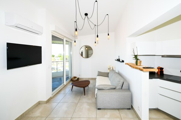 A modern kitchen with white cabinets, a built-in oven, and a countertop.