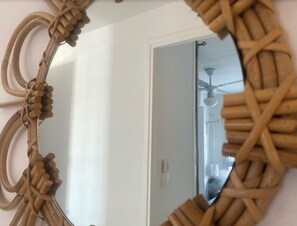 A mirror with a woven frame.