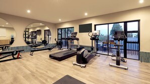 A gym with cardio machines, a bench, and a mirrored wall. - Hyatt House Johannesburg, Sandton (Sandton)